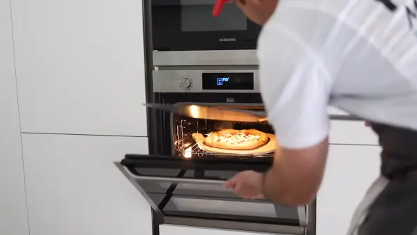 How can you prevent your pizza crust from getting soggy in an electric oven